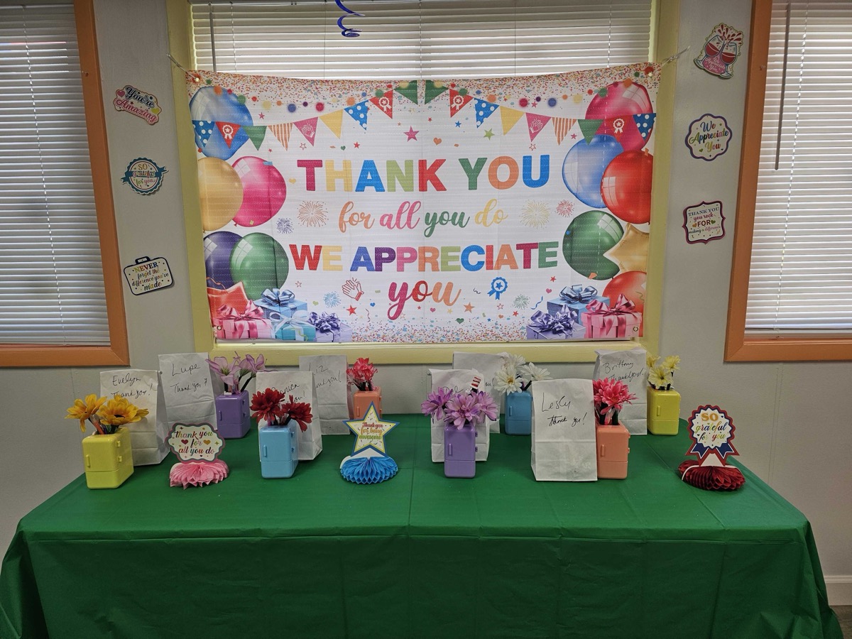 Personalized gift bags and flower arrangements set up for every teacher